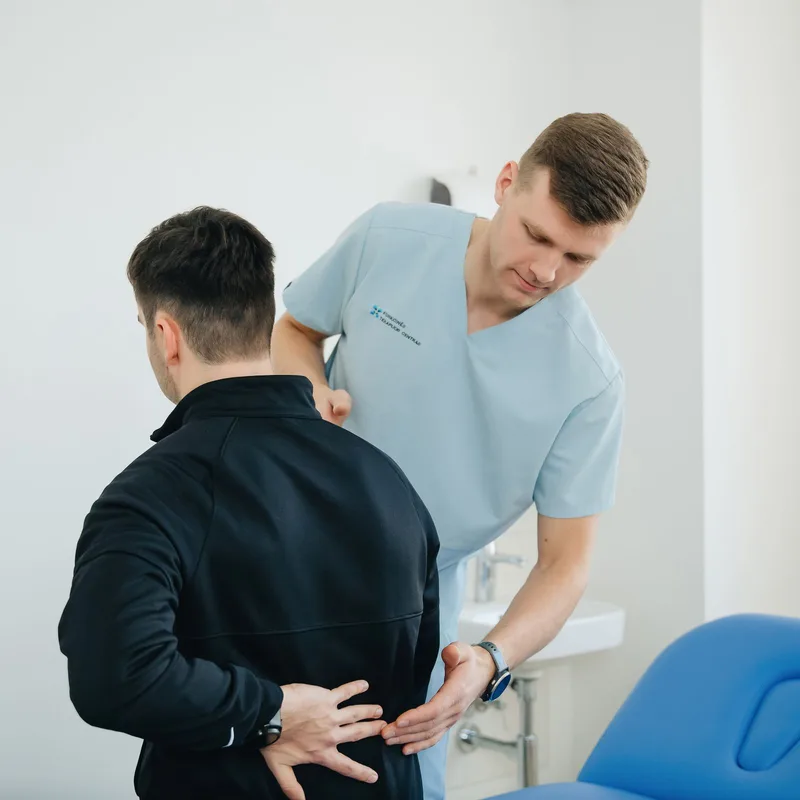 Professionnel accompagnant un patient lors d’un examen du dos